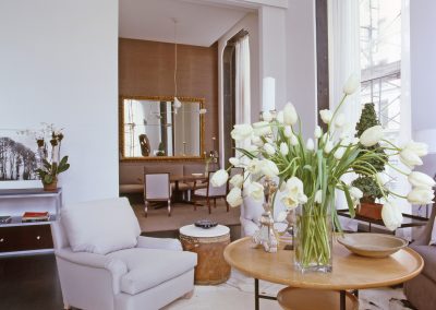 living room with chairs and flowers