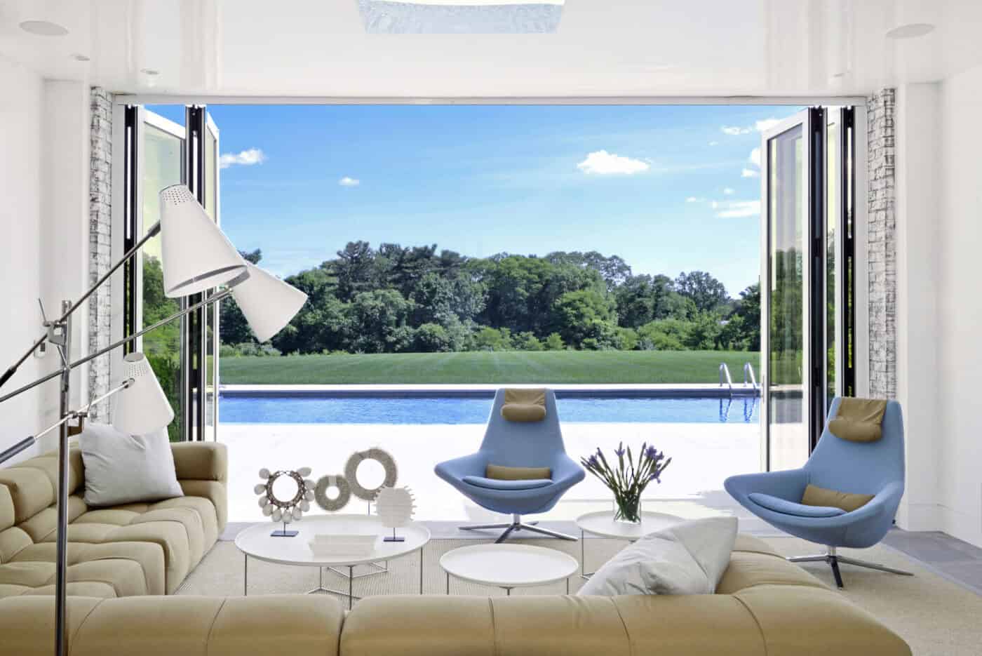 An open wall creates a seamless indoor-outdoor space. Chairs upholstered in performance fabric swivel from an inside view to an outside panorama.